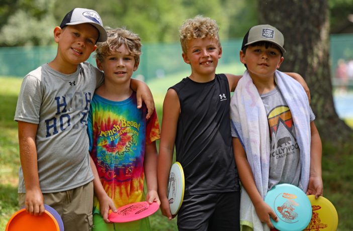 four campers enjoying a round of disc golf