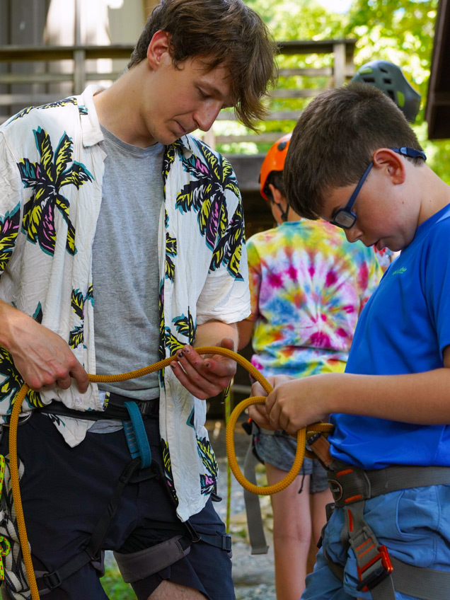 An image of a camp counselor engaged in an activity with a camper, showcasing the vibrant atmosphere and diverse opportunities available for summer jobs at camp